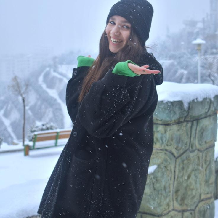 Kaveri Mehta, Lead Design Curator at GatherSparkPro, reviewing corporate floral arrangements